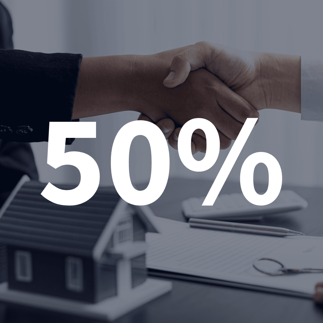 Business handshake with a house model, representing the 50% Capital Gains Inclusion Rate tax.
